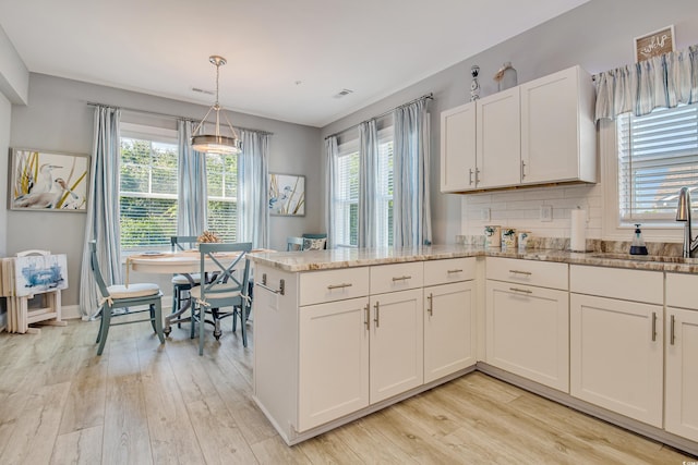 6203 Catalina Dr Unit 935, North Myrtle Beach, SC 29582 - kitchen featuring healthy amount of natural light, light wood finished floors, and light stone countertops