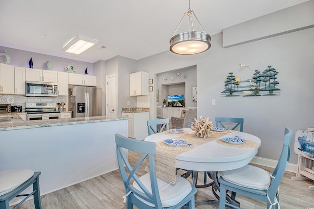 6203 Catalina Dr Unit 935, North Myrtle Beach, SC 29582 - dining area featuring light wood-style floors and baseboards