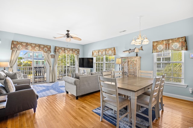 1020 Ocean Blvd S Unit A, Surfside Beach, SC 29575 - dining area featuring light wood-style floors, a chandelier, ceiling fan, and healthy amount of natural light