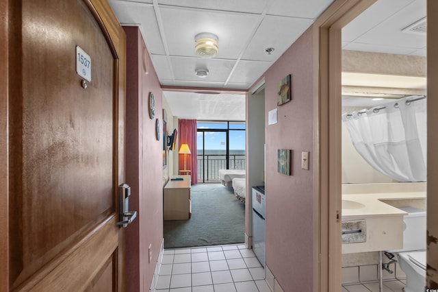 9550 Shore Dr Unit 1537/1538, Myrtle Beach, SC 29572 - hall featuring expansive windows, a water view, light colored carpet, and light tile patterned floors