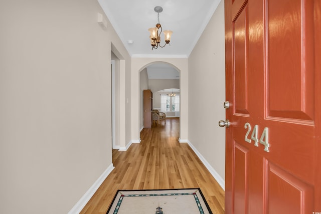 244 Devonbrook Pl, Longs, SC 29568 - entryway featuring arched walkways, a chandelier, light wood-type flooring, and ornamental molding