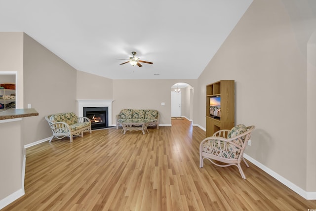 244 Devonbrook Pl, Longs, SC 29568 - living area featuring ceiling fan, light wood-style floors, arched walkways, lofted ceiling, and a glass covered fireplace
