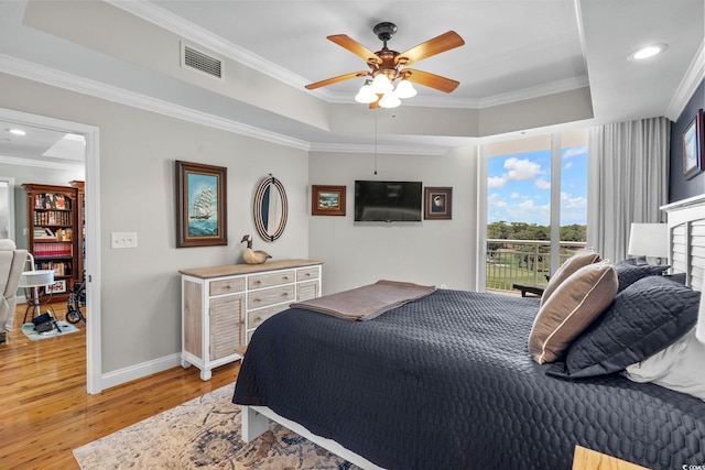 9547 Edgerton Dr Unit 405, Myrtle Beach, SC 29572 - bedroom featuring a raised ceiling, light wood-style flooring, crown molding, access to exterior, and recessed lighting