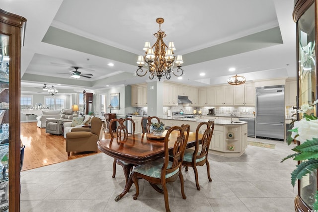 9547 Edgerton Dr Unit 405, Myrtle Beach, SC 29572 - dining area featuring a chandelier, a tray ceiling, light tile patterned flooring, crown molding, and recessed lighting