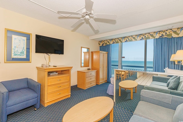 1304 N Ocean Blvd Unit 1104, Myrtle Beach, SC 29577 - living room with dark carpet, ceiling fan, and a textured ceiling