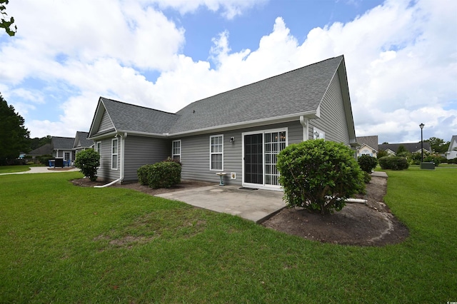 144 Balsa Dr, Longs, SC 29568 - back of property featuring a patio area, a lawn, and a shingled roof