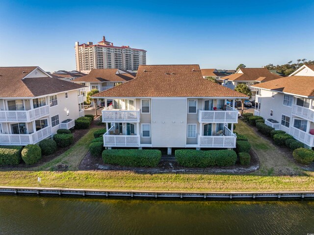 300 Shorehaven Dr Unit I-2, North Myrtle Beach, SC 29582 - back of house featuring a balcony, a water view, roof with shingles, and a residential view