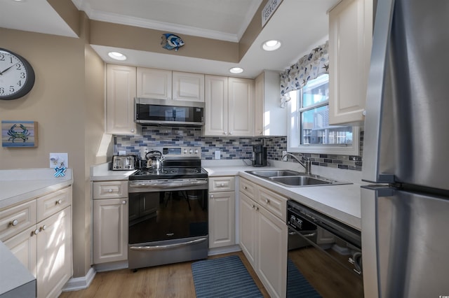 300 Shorehaven Dr Unit I-2, North Myrtle Beach, SC 29582 - kitchen with appliances with stainless steel finishes, crown molding, light countertops, decorative backsplash, and white cabinetry