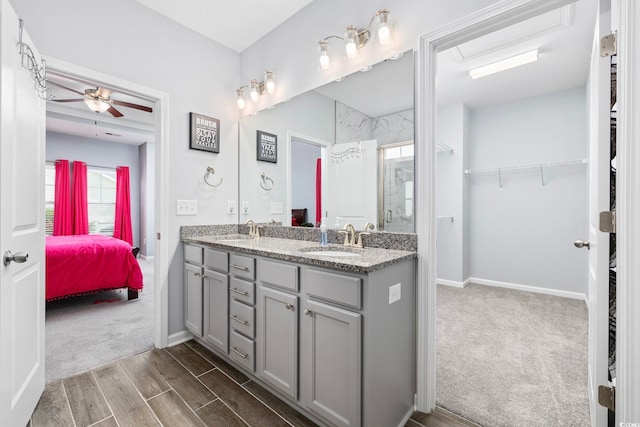 219 Glenmoor Dr, Conway, SC 29526 - ensuite bathroom featuring double vanity, a spacious closet, ceiling fan, wood finish floors, and a shower