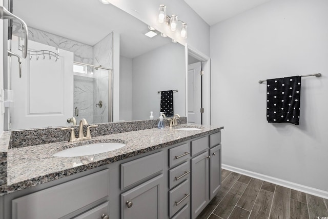 219 Glenmoor Dr, Conway, SC 29526 - bathroom with a marble finish shower, double vanity, and wood finished floors