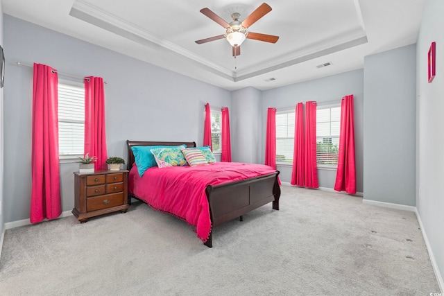 219 Glenmoor Dr, Conway, SC 29526 - carpeted bedroom featuring a tray ceiling, multiple windows, ornamental molding, and ceiling fan