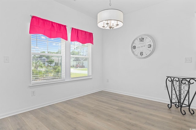 219 Glenmoor Dr, Conway, SC 29526 - unfurnished dining area featuring wood finished floors and a chandelier