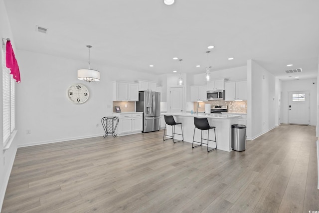 219 Glenmoor Dr, Conway, SC 29526 - kitchen with stainless steel appliances, recessed lighting, light wood-type flooring, light countertops, and decorative backsplash