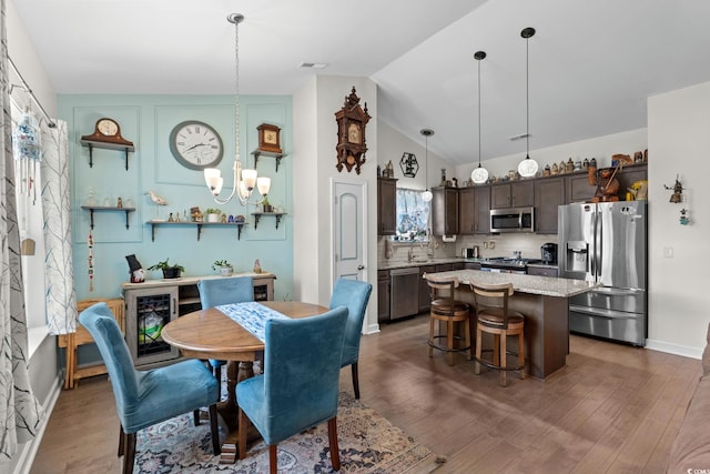 2781 Desert Rose St, Little River, SC 29566 - dining room with a chandelier, wood finished floors, and lofted ceiling