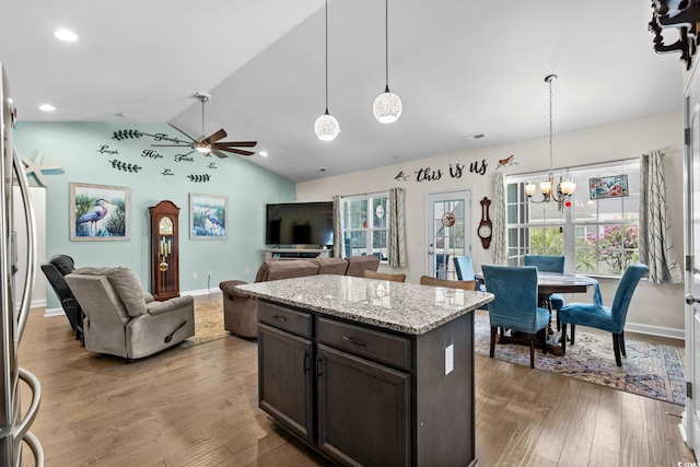 2781 Desert Rose St, Little River, SC 29566 - kitchen with ceiling fan, dark brown cabinets, lofted ceiling, a chandelier, and wood finished floors