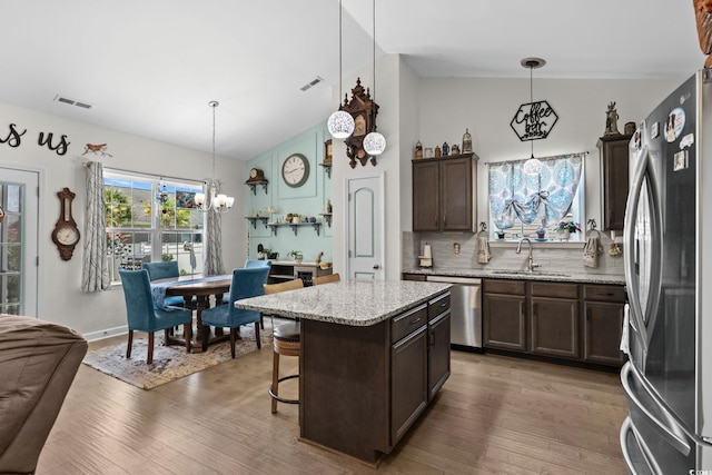2781 Desert Rose St, Little River, SC 29566 - kitchen with stainless steel appliances, a chandelier, dark brown cabinetry, wood finished floors, and lofted ceiling