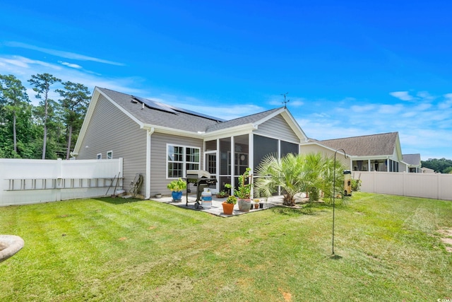2781 Desert Rose St, Little River, SC 29566 - rear view of property with a patio, roof mounted solar panels, a sunroom, a fenced backyard, and a shingled roof