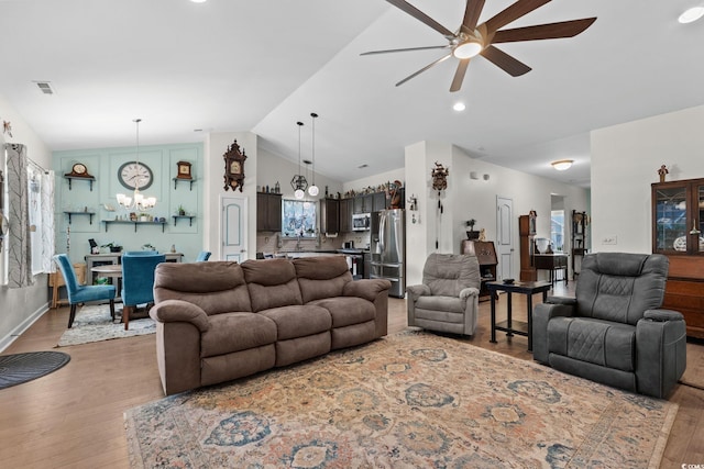 2781 Desert Rose St, Little River, SC 29566 - living area with vaulted ceiling, a ceiling fan, light wood-type flooring, a chandelier, and healthy amount of natural light