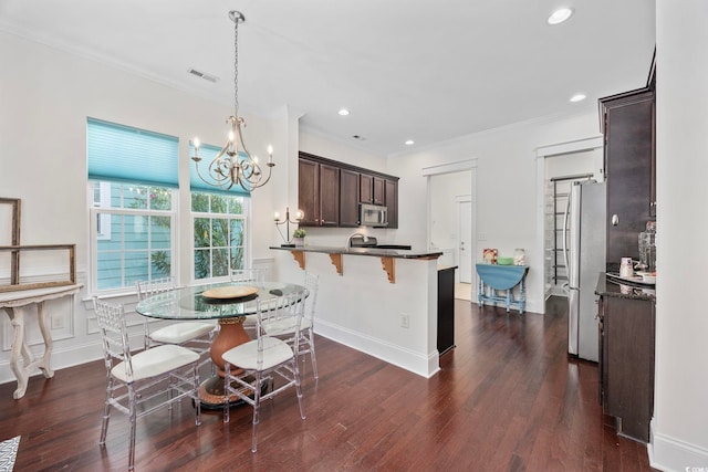 1348 Peterson St, Myrtle Beach, SC 29577 - dining space with a chandelier, ornamental molding, dark wood-type flooring, and recessed lighting