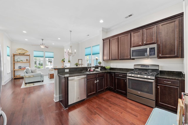 1348 Peterson St, Myrtle Beach, SC 29577 - kitchen featuring stainless steel appliances, dark brown cabinets, dark wood finished floors, open floor plan, and recessed lighting