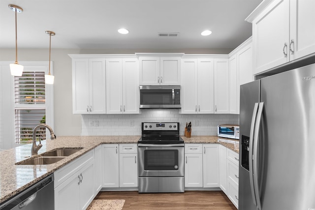 5304 Sea Coral Way N, Myrtle Beach, SC 29582 - kitchen featuring stainless steel appliances, white cabinetry, wood finished floors, backsplash, and recessed lighting