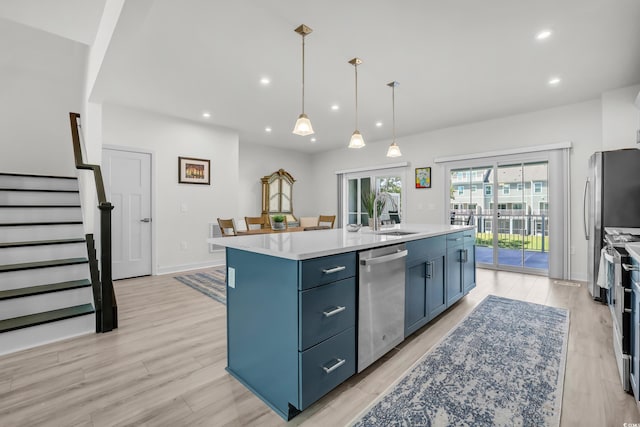 2557 Pete Dye Dr Unit 803, North Myrtle Beach, SC 29582 - kitchen with stainless steel appliances, blue cabinetry, an island with sink, recessed lighting, and light countertops