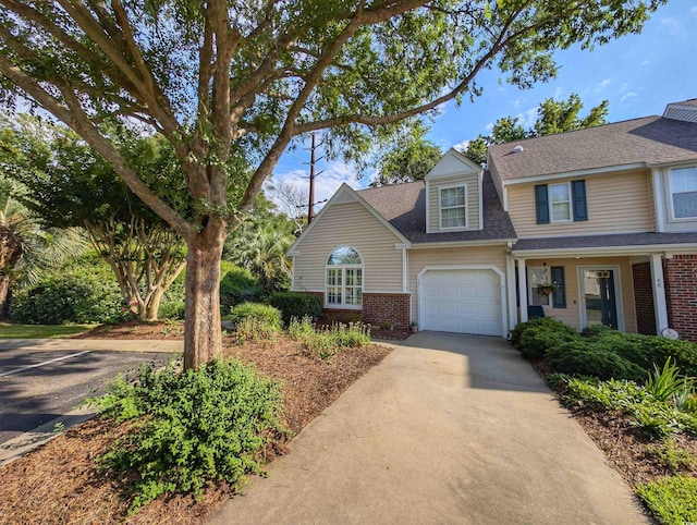 50 Pawleys Place Dr Unit 50, Pawleys Island, SC 29585 - view of front of home with brick siding, driveway, a garage, and a shingled roof
