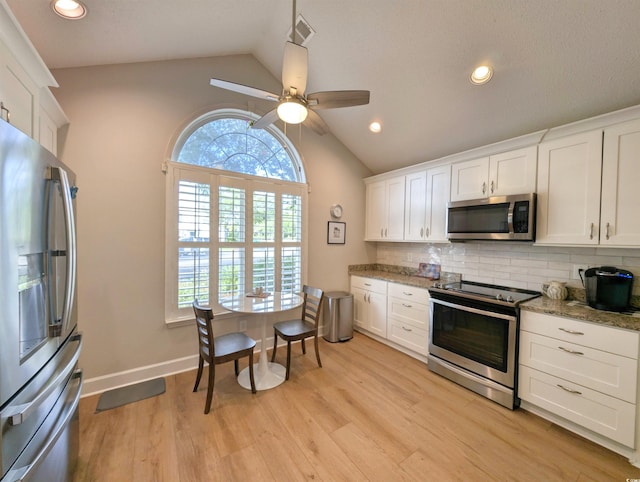 50 Pawleys Place Dr Unit 50, Pawleys Island, SC 29585 - kitchen featuring appliances with stainless steel finishes, vaulted ceiling, tasteful backsplash, white cabinetry, and recessed lighting