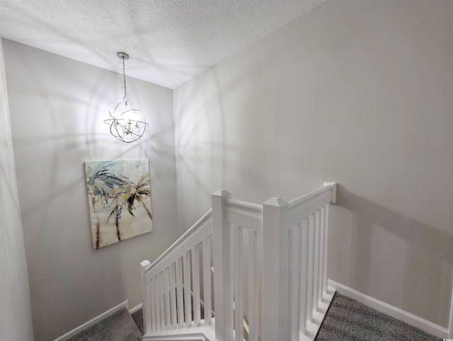 50 Pawleys Place Dr Unit 50, Pawleys Island, SC 29585 - stairs with a textured ceiling, carpet, and a chandelier