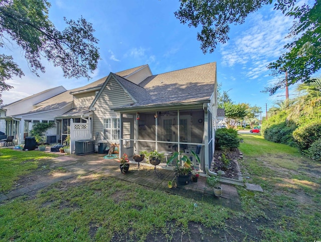 50 Pawleys Place Dr Unit 50, Pawleys Island, SC 29585 - back of property with a sunroom, roof with shingles, a yard, and a patio