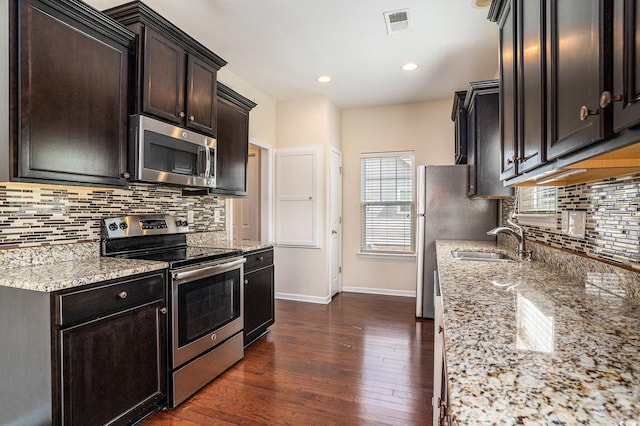 3619 White Wing Cir, Myrtle Beach, SC 29579 - kitchen featuring appliances with stainless steel finishes, dark wood-style flooring, tasteful backsplash, light stone countertops, and recessed lighting
