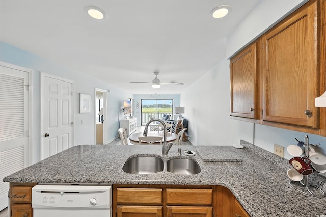 312 42nd Ave N Unit B2, North Myrtle Beach, SC 29582 - kitchen featuring dishwasher, brown cabinetry, a peninsula, and a ceiling fan