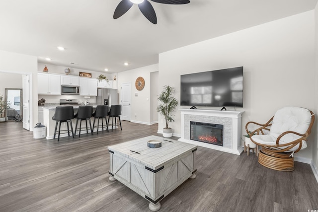 688 Wallace Dr, Little River, SC 29566 - living area with ceiling fan, dark wood-style flooring, recessed lighting, and a glass covered fireplace