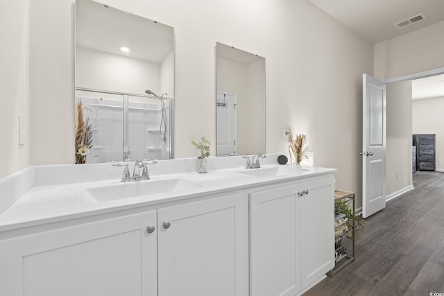 688 Wallace Dr, Little River, SC 29566 - bathroom with double vanity, wood finished floors, and a shower stall