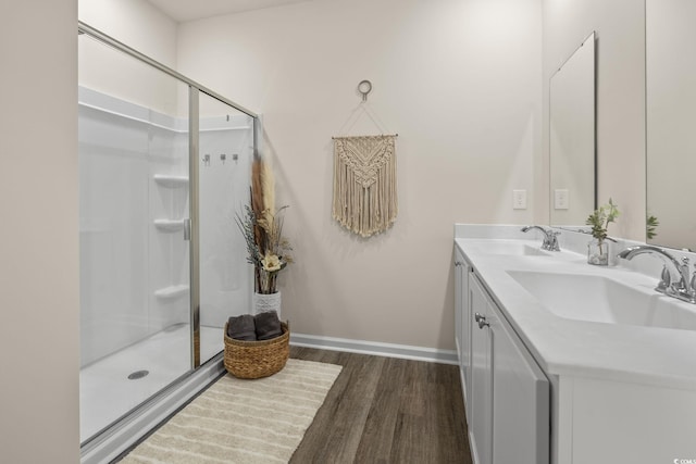 688 Wallace Dr, Little River, SC 29566 - full bathroom featuring wood finished floors, double vanity, and a shower stall
