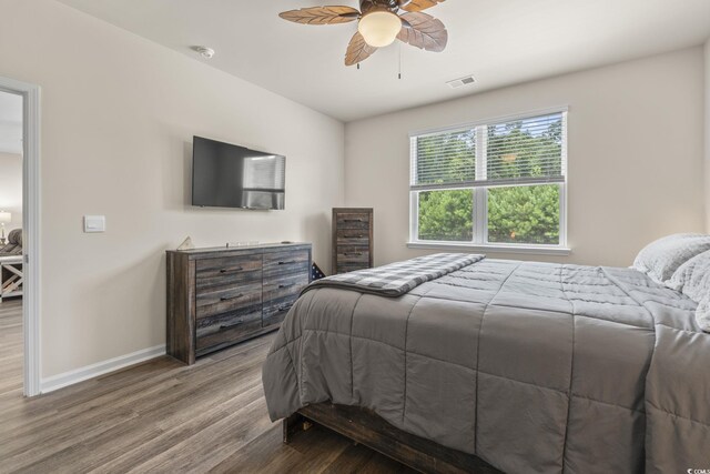 688 Wallace Dr, Little River, SC 29566 - bedroom featuring wood finished floors and a ceiling fan