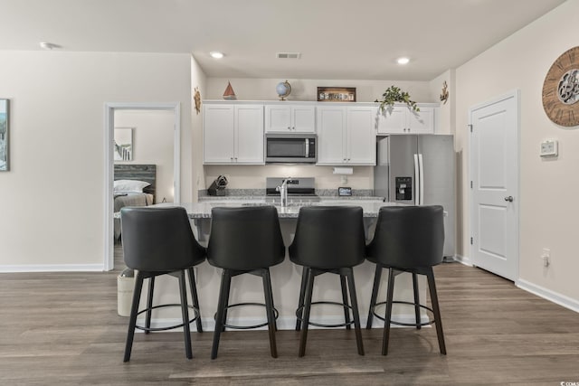 688 Wallace Dr, Little River, SC 29566 - kitchen featuring appliances with stainless steel finishes, white cabinets, dark wood-style flooring, and recessed lighting