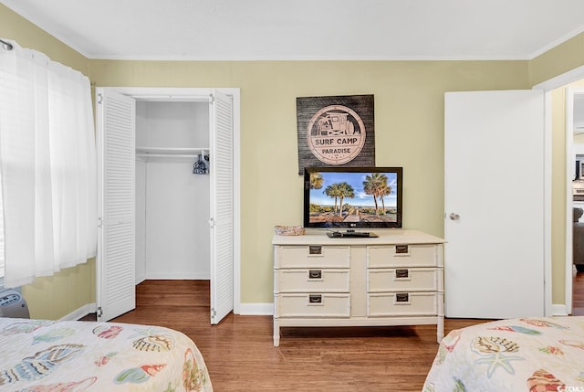 401 Hillside Dr N Unit 2F, North Myrtle Beach, SC 29582 - bedroom featuring wood finished floors, ornamental molding, and a closet