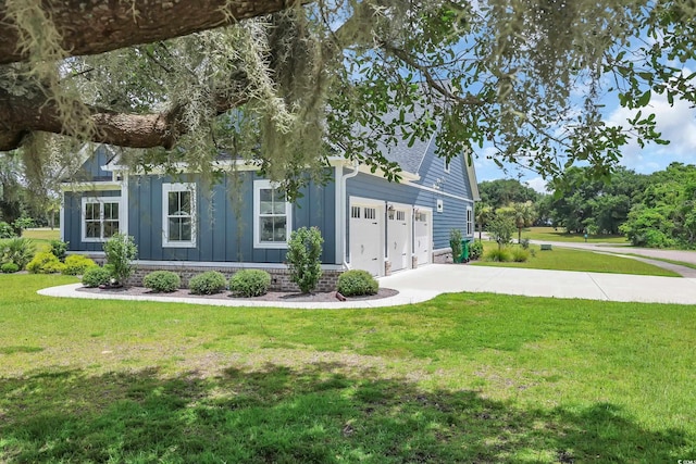 529 Oak Lawn Rd, Georgetown, SC 29440 - view of front of house with board and batten siding, driveway, a garage, and a front lawn