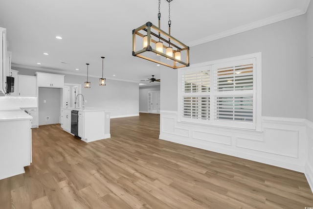 529 Oak Lawn Rd, Georgetown, SC 29440 - kitchen with open floor plan, crown molding, a ceiling fan, black microwave, and light countertops