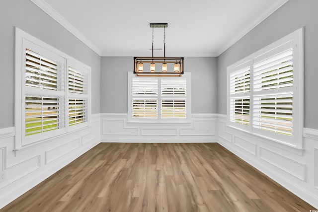 529 Oak Lawn Rd, Georgetown, SC 29440 - unfurnished dining area with a wainscoted wall, ornamental molding, and light wood-type flooring