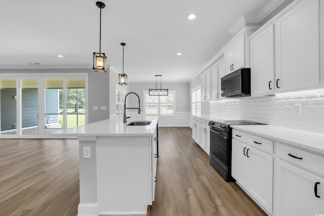 529 Oak Lawn Rd, Georgetown, SC 29440 - kitchen with black microwave, range with electric stovetop, light wood finished floors, light countertops, and recessed lighting