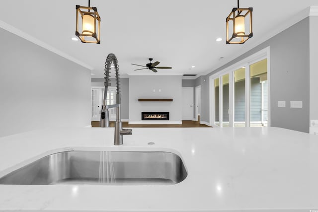 529 Oak Lawn Rd, Georgetown, SC 29440 - kitchen view of ceiling fan, crown molding, a glass covered fireplace, pendant lighting, and recessed lighting