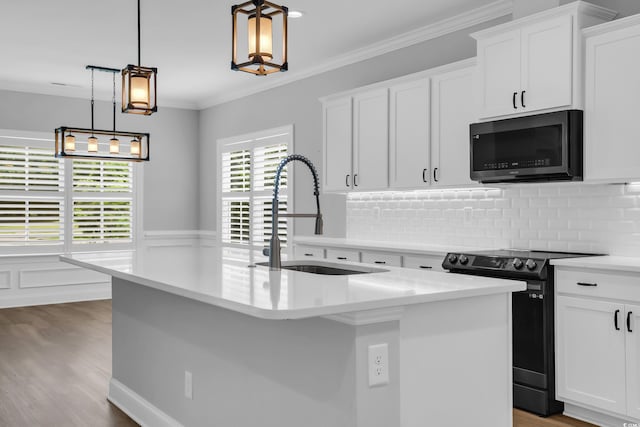 529 Oak Lawn Rd, Georgetown, SC 29440 - kitchen featuring black microwave, electric range oven, light countertops, wood finished floors, and ornamental molding