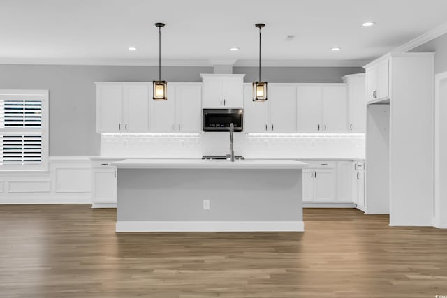 529 Oak Lawn Rd, Georgetown, SC 29440 - kitchen with stainless steel microwave, crown molding, white cabinetry, light countertops, and recessed lighting
