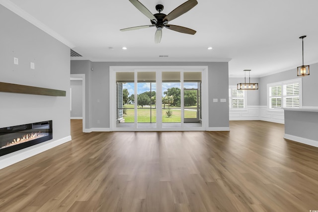 529 Oak Lawn Rd, Georgetown, SC 29440 - unfurnished living room featuring ornamental molding, a glass covered fireplace, a ceiling fan, wood finished floors, and recessed lighting