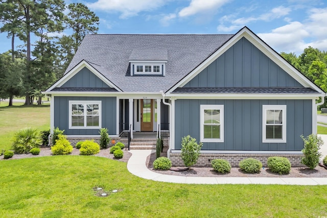 529 Oak Lawn Rd, Georgetown, SC 29440 - view of front of property with board and batten siding, roof with shingles, a porch, and a front yard