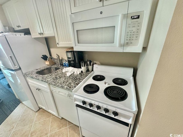 300 N Ocean Blvd Unit 1213, North Myrtle Beach, SC 29582 - kitchen featuring white appliances, light stone counters, white cabinetry, and light tile patterned flooring