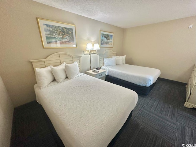 300 N Ocean Blvd Unit 1213, North Myrtle Beach, SC 29582 - carpeted bedroom featuring baseboards and a textured ceiling