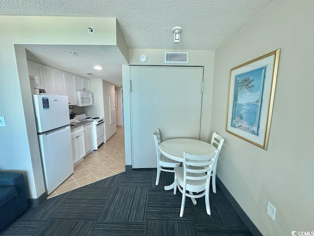 300 N Ocean Blvd Unit 1213, North Myrtle Beach, SC 29582 - dining space with a textured ceiling and light tile patterned flooring